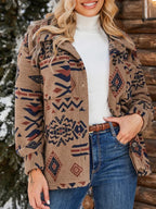 Woman wearing a brown fleece jacket with a geometric print, white turtleneck, and blue jeans, with one hand in pocket.