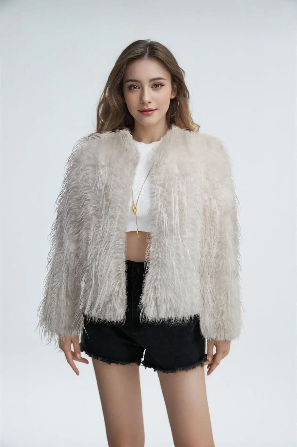 Woman wearing a light grey shaggy faux feather cropped jacket