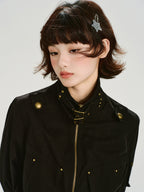 Close-up of black bomber jacket collar with buckle and stud details