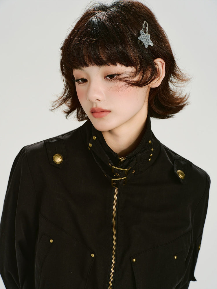 Close-up of black bomber jacket collar with buckle and stud details