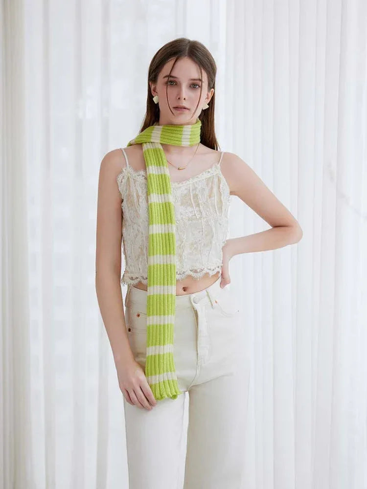 Woman wearing a long black and white striped knit scarf with ruffle edges - View 9 | WEUXS