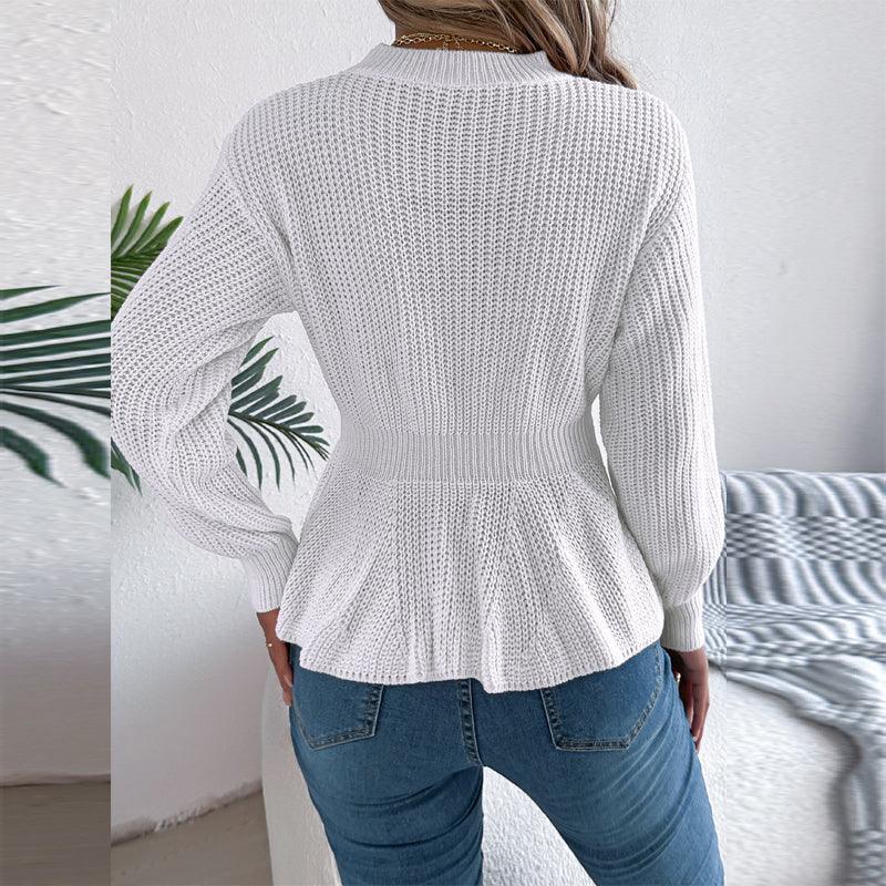 Back view of a white peplum sweater featuring a ribbed texture and long sleeves.