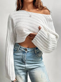 Back view of a woman in a pink cropped bell sleeve sweater
