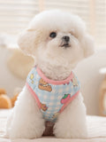 Light blue gingham dog vest with teddy bear and strawberry print, worn by a white bichon frise.