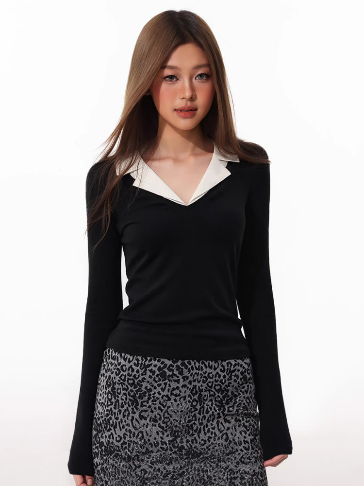 Woman wearing a black long-sleeve top with a white contrast collar and a leopard print skirt.