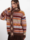 Woman adjusting the scarf of her striped turtleneck sweater.