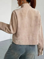 Back view of a woman in a beige corduroy cropped jacket.