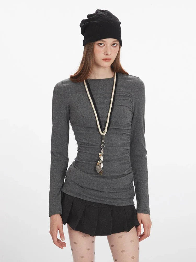 Model wearing heathered gray long sleeve top with round neck
