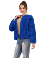 Front view of a woman in a royal blue cropped faux fur jacket.