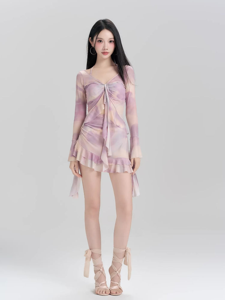 Woman wearing a lavender and peach tie-dye mesh long sleeve mini dress with ruffled hem