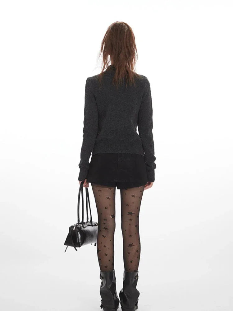 Back view of a woman wearing a dark grey knit cardigan.