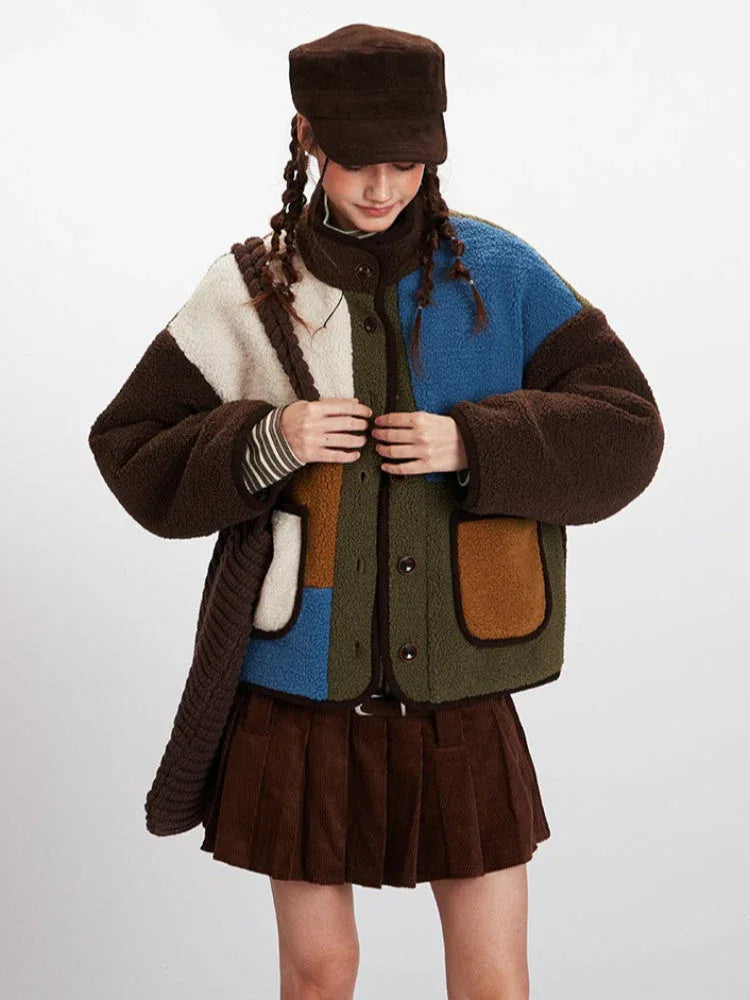 Woman buttoning up a color-block fleece jacket