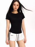 Close-up of a woman wearing a black fitted short-sleeve t-shirt