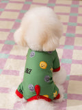 Rear view of a small white dog in a green dog pajama with planets and stars print