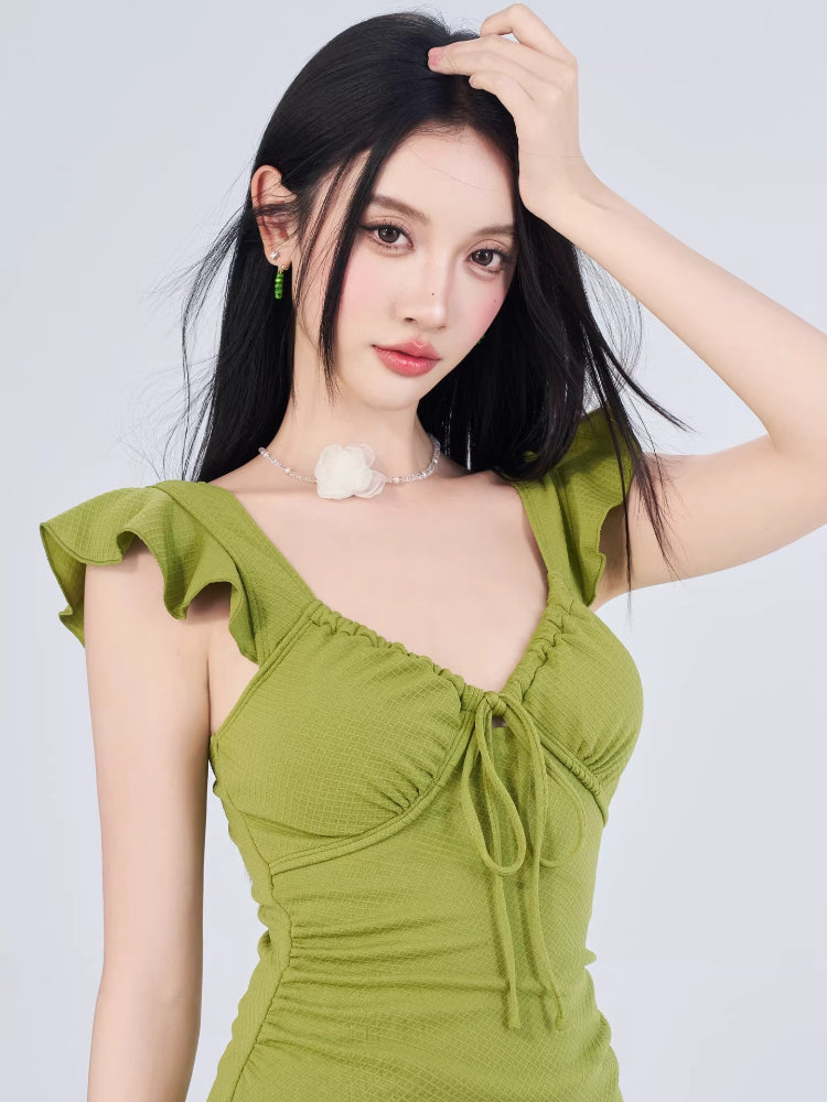 Close-up of the lime green dress neckline featuring ruffled sleeves and a tie-front detail.