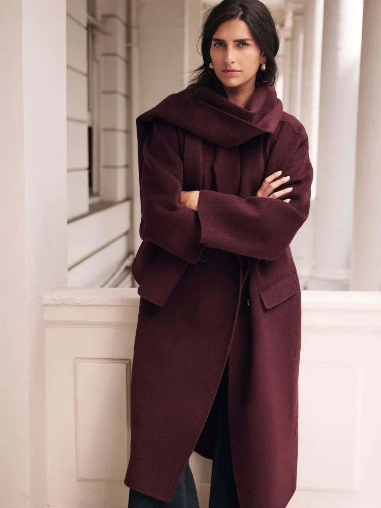 Woman wearing a burgundy double-breasted wool blend coat with a matching scarf