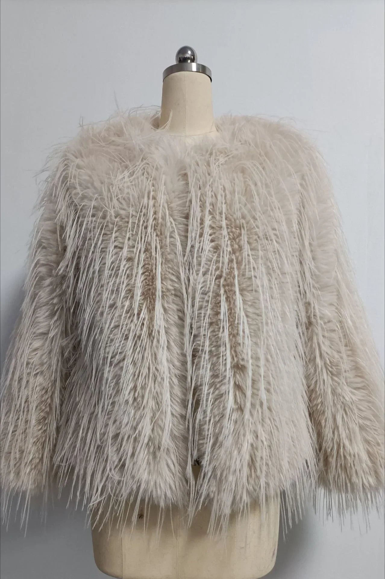 Cream shaggy faux feather jacket on a mannequin