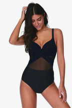 Woman wearing a black one-piece swimsuit with mesh accents and a criss-cross neckline