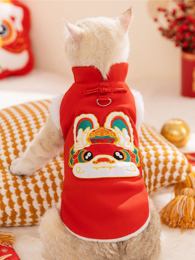 White cat wearing a red pet Tang suit vest with white faux fur trim
