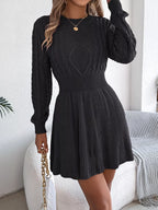 model wearing dark grey cable knit A-line sweater dress