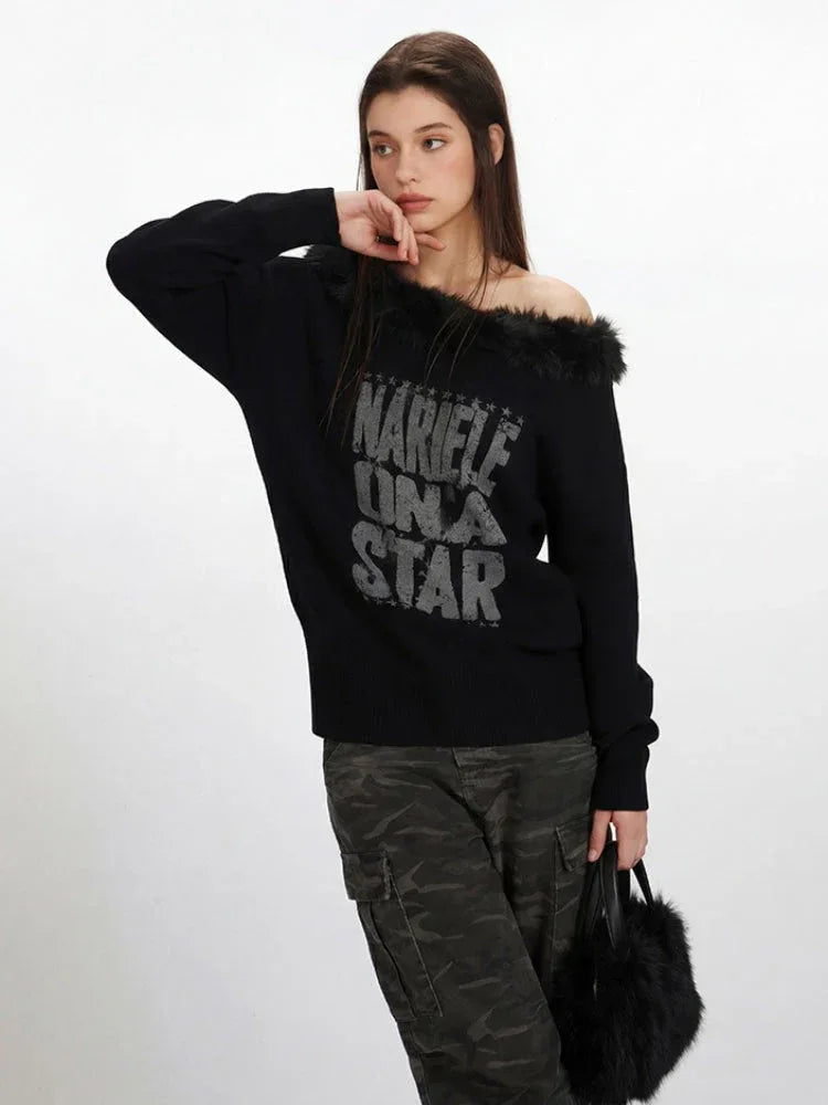 Side profile of a woman showcasing the off-the-shoulder design of a black knit sweater with faux fur trim and a graphic print.