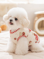 Cream-colored dog vest with teddy bear and floral print, featuring red gingham trim, worn by a white bichon frise.