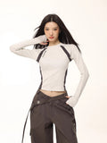 Model wearing a light grey long-sleeve athletic top with dark grey contrasting panels.