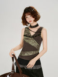 Model wearing a brown ribbed knit tank top with green textured print panels and decorative grommets