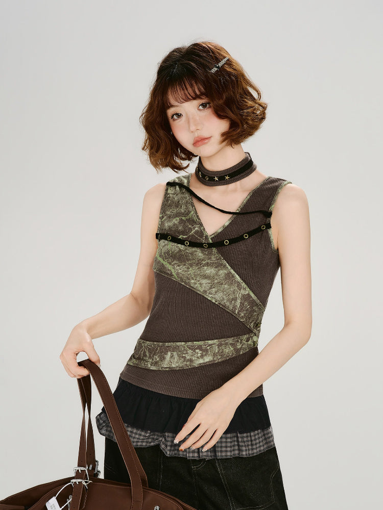 Model wearing a brown ribbed knit tank top with green textured print panels and decorative grommets