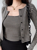 Front view of a woman in a houndstooth print cropped cardigan and camisole set.