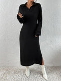 Front view of a woman in a black ribbed knit midi dress with a pointed collar and v-neck, accessorized with a white handbag.