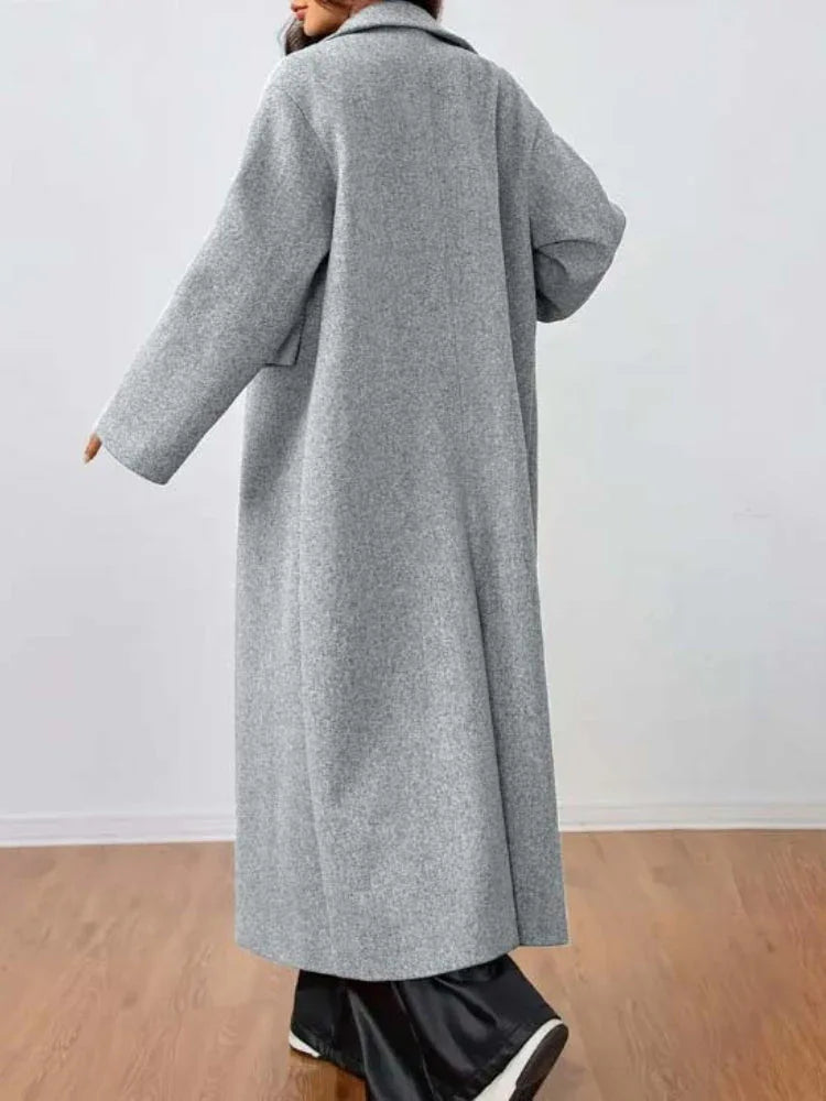 Rear view of a woman wearing a grey longline wool blend coat.