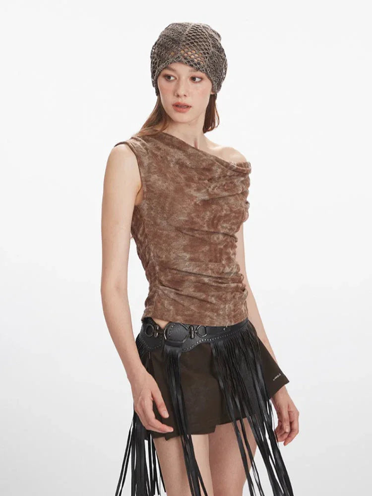 Close-up of a model wearing a brown textured knit top with an asymmetrical neckline and draping.