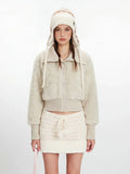 Close-up of the cream fuzzy cropped jacket with button details