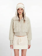 Close-up of the cream fuzzy cropped jacket with button details