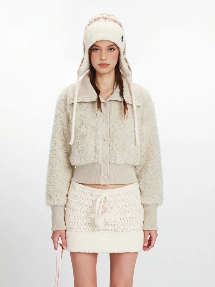 Close-up of the cream fuzzy cropped jacket with button details