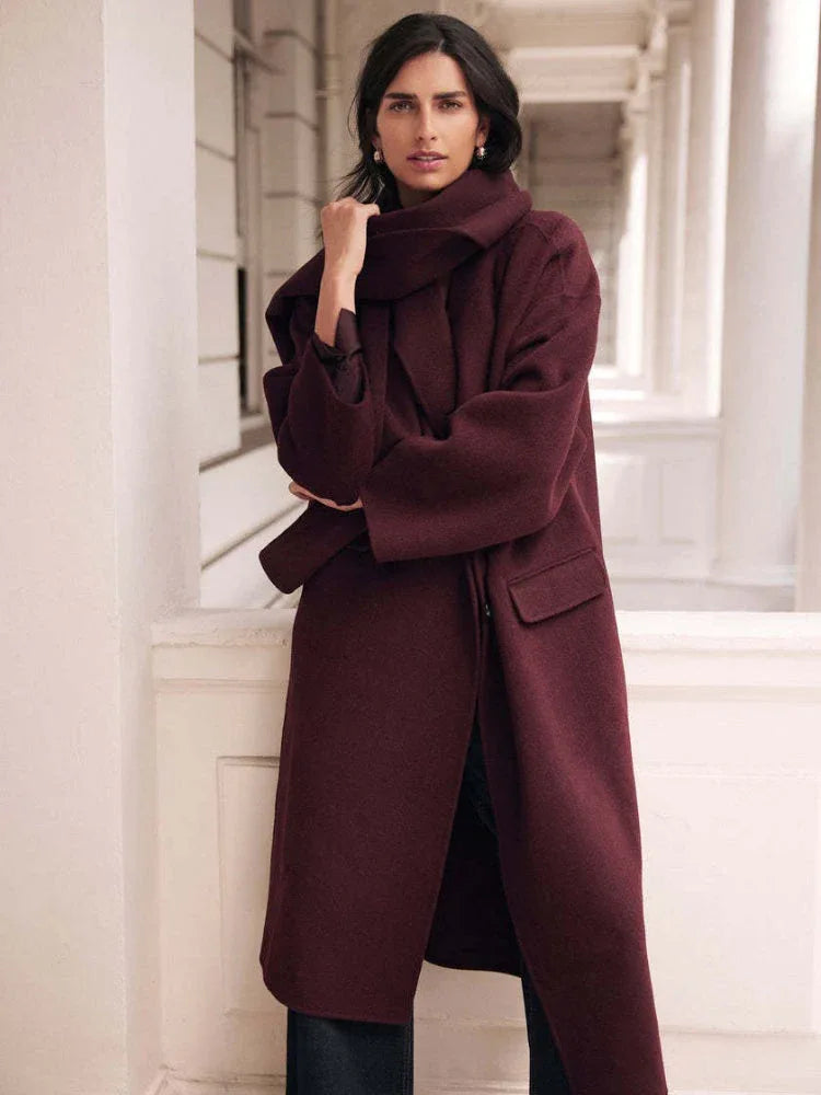 Close-up of a woman wearing a burgundy wool blend coat