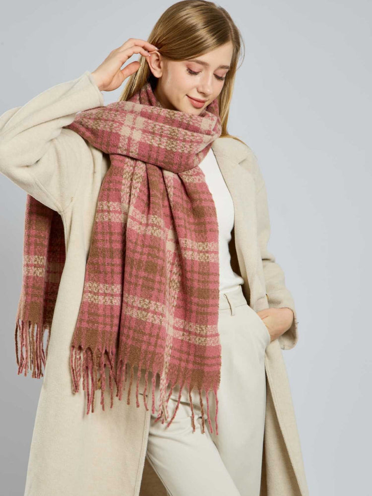 Lifestyle image of a woman wearing a cozy plaid scarf.