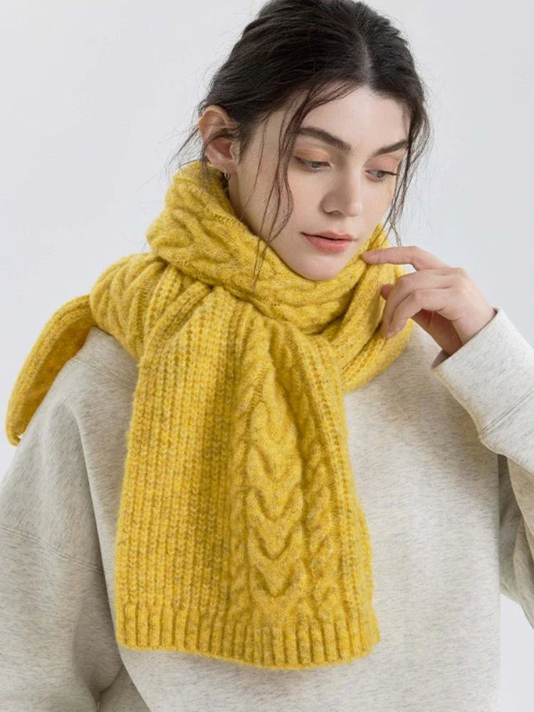 Model posing with a yellow scarf around her neck