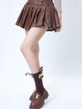 Model wearing brown crew socks with a green monster applique