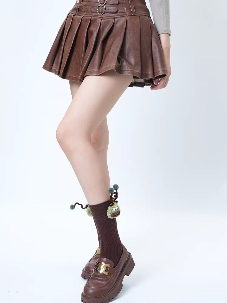 Model wearing brown crew socks with a green monster applique