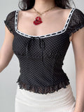 Detail of the contrasting white trim and ruffled hem on the sheer top