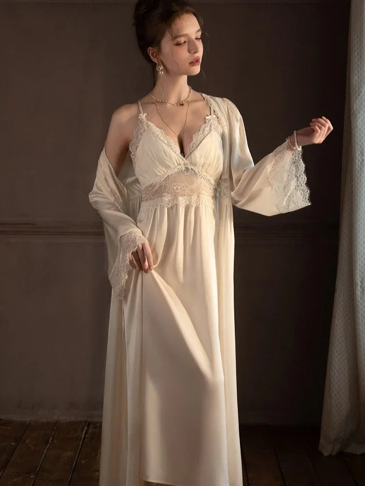 Woman wearing a cream-colored satin slip dress with lace trim and a matching long robe.