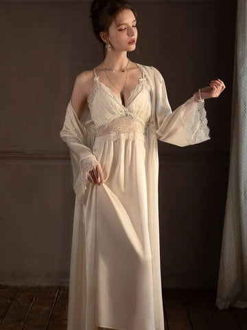 Woman wearing a cream-colored satin slip dress with lace trim and a matching long robe.