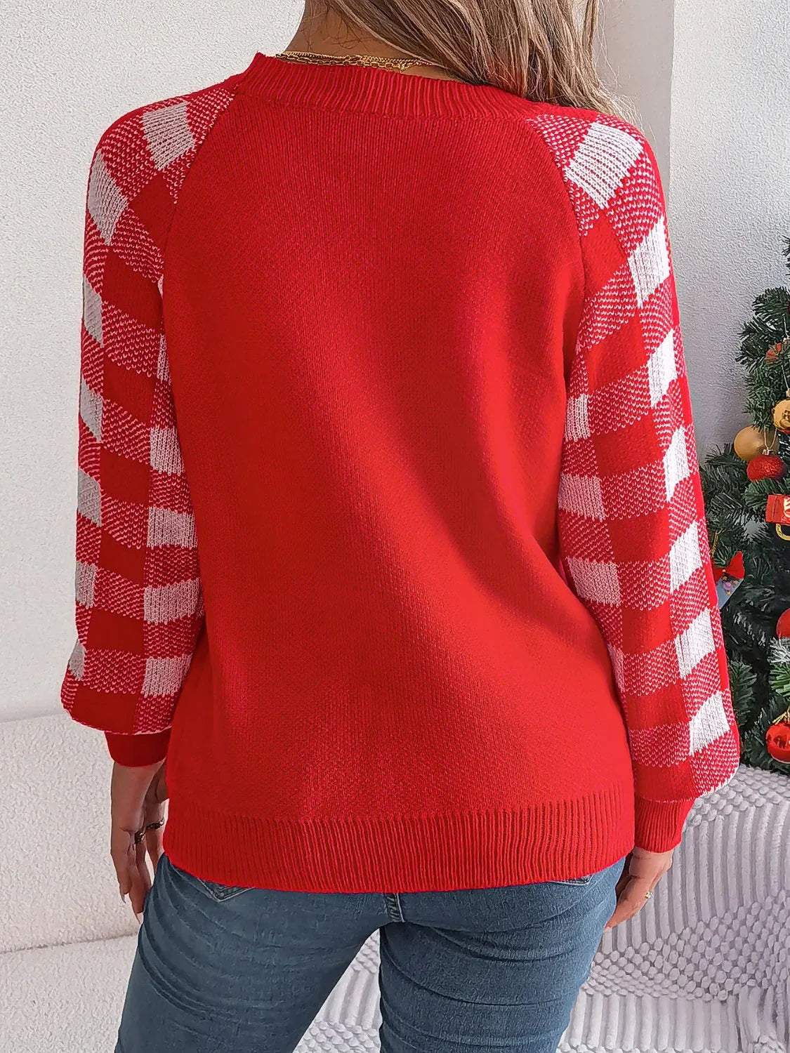 Woman wearing a white and red festive reindeer knit sweater with buffalo plaid raglan sleeves. - View 10 | WEUXS