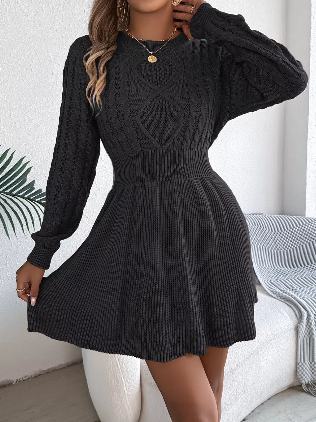 close-up of black lantern sleeve cable knit dress