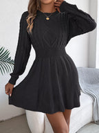 close-up of black lantern sleeve cable knit dress