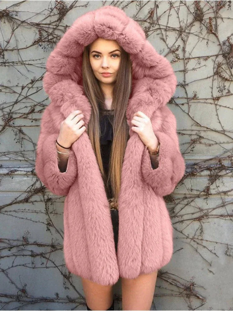 Woman wearing a pink hooded faux fur coat.