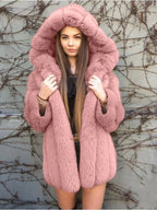 Woman wearing a pink hooded faux fur coat.