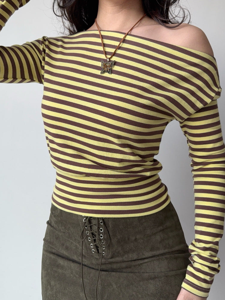 A model displays a striped long-sleeve top with a relaxed fit and a wide neckline.